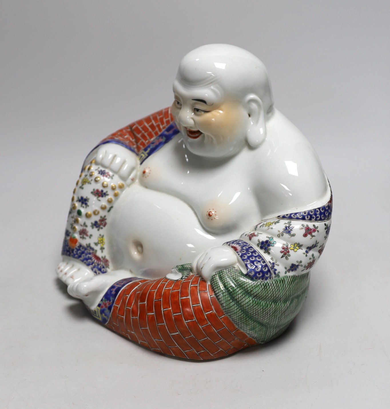 A Chinese famille rose figure of Budai, 23cm tall